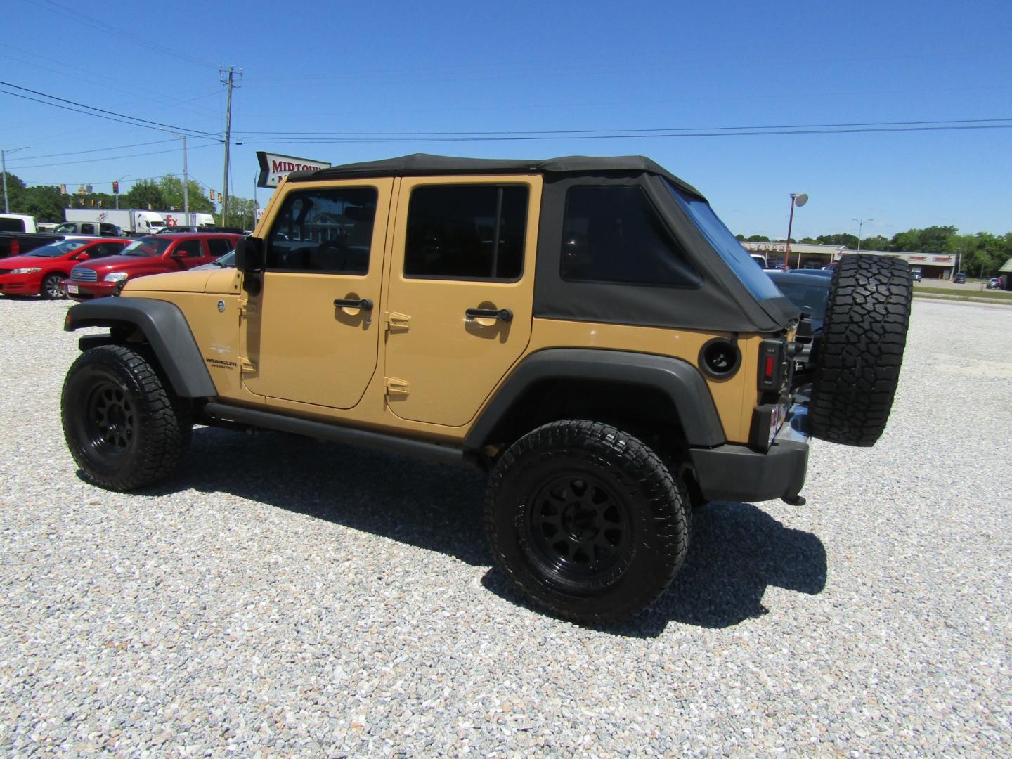 2013 Tan /Black Jeep Wrangler Unlimited Sahara 4WD (1C4HJWEG7DL) with an 3.6L V6 DOHC 24V FFV engine, Automatic transmission, located at 15016 S Hwy 231, Midland City, AL, 36350, (334) 983-3001, 31.306210, -85.495277 - Photo#5